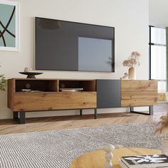 a large flat screen tv mounted to the side of a wooden cabinet in a living room