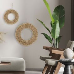 a living room filled with furniture next to a plant and potted plant on top of a table