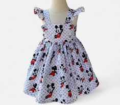 Girls Mickey inspire dress, Ruffle sleeve mouse dress, Birthday Mickey dress Dress is a done in a cotton fabric. It closes in the back with buttons, bodice fully lined, skirt has plenty of fabric, ruffles in the sleeves. All our dresses are finish with a serger for a professional look and long lasting. Size chart available in the listing to select the correct size. All our items are handmade and made to order.   As each dress is made to order, the placement in the fabric may change from the pictures in the listing. If your order needs to be done and ship before my turnaround ( ship date in your order ) please mention date needed in Notes To Seller. If any question please do not hesitate to contact us. Playful Minnie Mouse Summer Dress, Sleeveless Minnie Mouse Dress For Spring, Cute Minnie Mouse Spring Dress, White Minnie Mouse Summer Dress, Spring Cotton Minnie Mouse Dress, Fabric Ruffles, Mouse Dress, Mickey Party, Dress Birthday