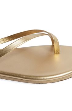 Shimmering metallic leather adds a luxe statement to this toe-loop flip-flop set on a lightweight, minimalist footbed serving all-day comfort. Water-resistant Leather upper and lining/rubber sole Made in Brazil Sleek Gold Sandals For Summer, Sleek Gold Sandals With Single Toe Strap, Sleek Metallic Sandals For Summer, Sleek Gold Leather Sandals, Gold Leather Flat Flip Flops, Gold Synthetic Sandals With Single Toe Strap, Gold Open Toe Synthetic Flip Flops, Gold Toe Post Sandals With Cushioned Footbed, Gold Sandals With Single Toe Strap