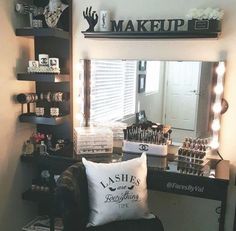 a chair with a pillow on top of it in front of a mirror and shelves