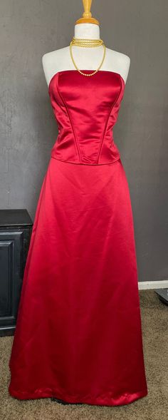 1990s-00's Formal 2 piece Strapless Gown set from Bill Levkoff, size 16 tag (please see measurements for best fit). Crisp Red Thick Satin Polyester fabric, lined in Red soft lightweight Acetate fabric. Fabulous Gown when worn together, or we love a White button down knotted at the waist paired with the skirt, a Graphic T, or Wearing the Bustier top with Jeans, or Tux Pants. Top has Ribbon Corset Lacing at the back- it is Decorative. Supportive Boning, Side zipper with hook and eye at top + Botto Formal Fitted Floor-length Maxi Skirt, Fitted Floor-length Maxi Skirt For Formal Occasions, Red Floor-length Party Skirt, Red Floor-length Skirt For Party, Fitted Satin Maxi Skirt, Fitted Satin Skirt For Prom, Elegant Fitted Maxi Skirt For Prom Season, Fitted Skirt For Formal Prom Season, Fitted Floor-length Skirt For Prom