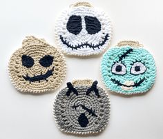 three crocheted coasters with faces on them