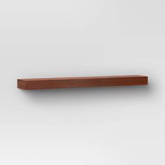 a wooden shelf mounted on the wall