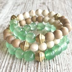 Wow, this one is a looker! The SEAFOAM stack gives off all the warm and pretty feels of the surf meeting the sand. Made with soft muted seafoam-green aventurine gemstones, creamy Calcutta style marble beads, taupe wood beads and gold accents. Buy one or buy all three to create this stunning stack! Save BIG when purchasing all three. (If purchasing one, please note bracelet preference in check out: green, cream/taupe combo or green/cream/taupe combo.)         *Made 7 inches in length for standard wrist unless a custom size is noted in checkout.  *Comes gift-giving-ready with a Salty Sunshine branded tag, sheer drawstring bag and crinkle paper. Holiday gift packing available for small fee - see separate listing.  *Free shipping on orders $35 and up! Follow Salty Sunshine Jewelry on Instagram Leather Jewelry Bracelet, Colorful Bead Bracelets, Cream Marble, Gold Bracelets Stacked, Green Beaded Bracelets, Beaded Jewelry Designs, Beach Lover, Agate Bracelet, Green Cream