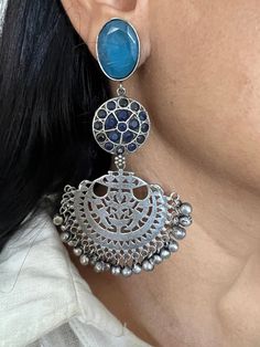 Premium Quality, Silver Replica at its best. Complement your personality with this gorgeous Earrings. Handcrafted in brass, oxidized, stones The weight of the Earrings is 38 grams per pair. The length of the earrings is 10 cm. The width of the earrings is 5 cm. Oxidized Brass Jhumkas, Fusion Style Chandbali Jewelry With Oxidized Finish, Festive Brass Earrings With Oxidized Finish, Fusion Metal Danglers, Silver Oxidized Finish Earrings, Temple Jewelry Brass Danglers With Oxidized Finish, Oxidized Brass Chandbali Danglers, Blue Oxidized Finish Earrings, Brass Temple Jewelry Danglers With Oxidized Finish