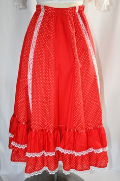 "A vintage 1970s very full pieced or patchwork red and white polka dot and solid red button front prairie skirt with white lace trim and ruffles. The skirt has an elastic waist, which measure 24 inches, stretching to 36 inches. The skirt can be unbuttoned from the hem to about 5 inches below the waist. The skirt is made of vertical panels alternating between the polka dot and solid red. There are rows of white lace running down four seams at the front, two seams in the back. There are two layere Vintage Red Ruffled Skirt, Vintage Red Skirt With Ruffles, Red Ruffled Summer Petticoat, Red Ruffled Petticoat For Summer, Vintage Red Fitted Petticoat, Skirt Ruffles, Prairie Skirt, Polka Dot Fabric, Solid Red