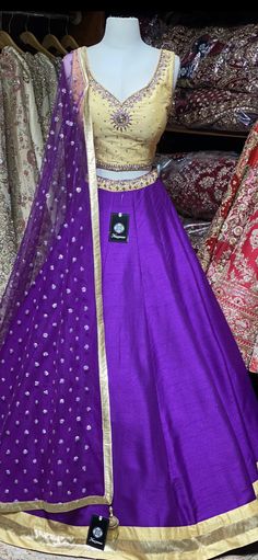 Violet purple skirt paired with contrasting golden zardozi and stone work blouse and net sequins butti dupatta. Fabric: Raw Silk This outfit can be customized in multiple colors and specific to client measurements. 90 days of production time is required and are for bulk orders only! Orders are processed in store only! Final fittings/alterations not included. Minimum Order Quantity- 4 pieces Designer Purple Raw Silk Salwar Kameez, Designer Raw Silk Purple Salwar Kameez, Designer Wear Purple Raw Silk Salwar Kameez, Gold Cutdana Traditional Party Wear, Purple Raw Silk Sets With Zari Work, Purple Anarkali Set In Raw Silk, Purple Anarkali Raw Silk Set, Anarkali Purple Raw Silk Set, Art Silk Traditional Wear With Zari For Party