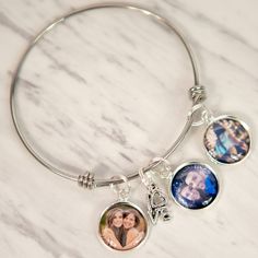 "Savor the Memories with this beautiful Personalized Photo Bracelet. This photo bracelet makes the perfect gift for Mom or Grandma this holiday season! This Photo Bracelet is available in silver or gold color and features: ♥ Stainless Steel Photo Charm Bracelet is approximately 2.55\" in diameter ♥ LOVE Charm ♥ Include up to 5 photos ♥ Ships fast! Photo Bracelet comes in a kraft box ready to give as a gift. -- SENDING PHOTOS -- After ordering please attach your photos to an etsy conversation or Silver Heart Bracelets For Best Friend Gift, Heart-shaped Silver Bracelets For Best Friend Gift, Charm Bracelet For Best Friend Gift On Valentine's Day, Valentine's Day Charm Bracelet For Best Friend, Personalized Gift Charm Bracelet For Valentine's Day, Silver Heart Bracelet For Best Friend On Mother's Day, Customizable Round Jewelry For Friendship, Customizable Adjustable Charm Bracelet, Personalized Valentine's Day Charm Bracelet