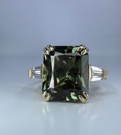 Wow picks! Radiant Cut Olive Green Sapphire Engagement Ring 14K White Gold Unique Vintage Olive Green Sapphire Engagement Rings Green Sapphire Ring at $695.00 Choose your wows. 🐕 #TravelRing #AnniversaryGift #EngagementRing #PromiseRing #ProposalRing #RectangleShape #WeddingRing #BirthdayGift #RadiantCut #LadiesRing Luxury Green Sapphire Ring For Women, Green Sapphire Baguette Ring, Olive Green Engagement Ring, Green Sapphire Rings, Radiant Cut Gold Sapphire Anniversary Ring, Gold Radiant Cut Sapphire Ring For Anniversary, Gold Sapphire Ring For Anniversary, Radiant Cut, Radiant Cut Gemstone For Wedding And Anniversary, Radiant Cut Gemstone Ring For Anniversary