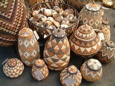 several baskets and bowls are sitting on the ground