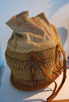 This magnificent hand woven carry-all or large purse has a leather top, with drawstring closure.  The body of the bag is woven in an intricate basket weave, and the handles, straps, and all acourtrements are made from leather.  I believe it is from South America, as I have had Indonesian woven bags and they have not had the proliferation of leather bindings.  Please examine the photographs carefully.  It measures approximately 18 inches high, 13 inches wide and 12 inches deep.  For the initial p Natural Leather Basket-shaped Bucket Bag, Natural Leather Basket Bucket Bag, Leather Bucket Bag With Braided Handles In Basket Shape, Basket-shaped Travel Bag With Braided Details, Travel Basket Bag With Braided Details, Natural Intrecciato Weave Bucket Bag For Travel, Weaved Bucket Bag For Market, Leather Bucket Straw Bag For Market, Weaving Bucket Bag For Travel