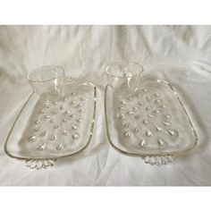 two clear glass dishes on a white sheet