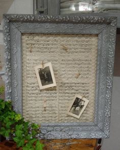 an old photo frame with two pictures hanging on the wall next to a potted plant