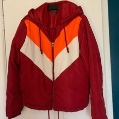 Retro Style 70s 80s Puffer Jacket. Hooded With Drawstrings. Drawstrings Along The Hem. Red, Orange And White. Chevron Pattern On Front. Zipper Closure. Two Side Pockets. Nice Seasonal Transition Jacket! Recycled Polyester. Never Worn. Trendy Hooded Windbreaker For Cold Weather, Trendy Red Windbreaker For Fall, Trendy Red Fall Windbreaker, Retro Hooded Fall Windbreaker, Red Fall Windbreaker With Drawstring Hood, Retro Hooded Windbreaker For Fall, Retro Long Sleeve Hooded Jacket For Fall, Red Windbreaker With Drawstring Hood For Fall, Retro Hooded Jacket With Pockets For Fall