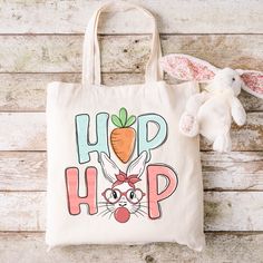 a tote bag with the words hip hop on it next to a stuffed bunny