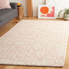 a living room with a couch, chair and rug