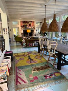 a room filled with lots of furniture next to a dining table and bookshelves