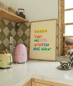 a kitchen counter with toaster, kettle and sign on it that says chef was cute, wild eat here again