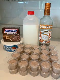 there are many cups on the counter with milk and other ingredients to make desserts