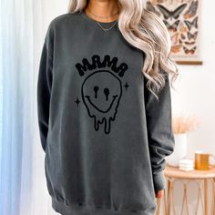 Luxurious comfort and style are what this unisex, garment-dyed sweatshirt is all about. It's made with 80% ring-spun cotton and 20% polyester and the fabric is 3-end garment-dyed, ring-spun, color-blast fleece with a 100% cotton face. Each sweatshirt comes with a relaxed fit, a rolled-forward shoulder, and a back neck patch.  .: 80% ring-spun cotton, 20% polyester .: Medium-heavy fabric (9.5 oz /yd² (322.1 g/m .: Relaxed fit .: Sewn in twill label .: OEKO-TEX certified low-impact dyes CARE INSTRUCTIONS: wash cold/tumble dry low heat Trendy Cotton Sweatshirt For Mother's Day, Casual Black Sweatshirt For Mother's Day, Casual Crew Neck Sweatshirt For Mother's Day, Casual Sweatshirt For Mother's Day Loungewear, Relaxed Fit Sweatshirt For Mother's Day Loungewear, Mother's Day Relaxed Fit Sweatshirt For Loungewear, Melty Smiley Face, New Mom Shirt, Trendy Mom