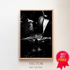 a black and white photo hanging on the wall next to a wine glass with a man in a tuxedo