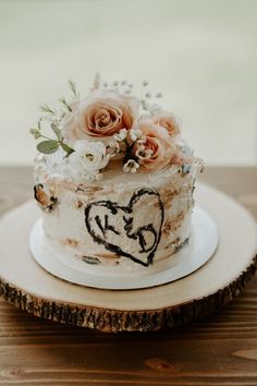 a wedding cake decorated with flowers and hearts