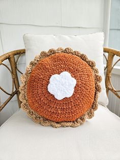 a crocheted pillow sitting on top of a chair