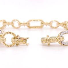 This bracelet is the perfect addition to any fine jewelry collection! The design has pave diamond links alternating with beaded gold links, giving the bracelet a versatile and unique look. The diamonds are bright white, adding contrast next to the rich, yellow-gold links. The beaded texture allows light to reflect off this bracelet from every angle making the bracelet shimmer in any setting! Metal Quality: 14KLength: 7 inchesWidth: 9.5 millimetersClasp: Hidden Box ClaspDiamond Shape: Round Brill Elegant Diamond Link Bracelet, Luxury Cubic Zirconia Tennis Bracelet With Solid Link Construction, Fine Jewelry Diamond Tennis Bracelet, Elegant Diamond Cut Link Chain Bracelet, Luxury Link Diamond Bracelet For Anniversary, Luxury Diamond Oval Link Bracelets, Diamond Tennis Bracelet In Fine Jewelry Style, Luxury Diamond Link Bracelet For Anniversary, Fine Jewelry Diamond Tennis Bracelet With Solid Link