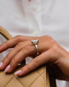 a close up of a person holding a handbag