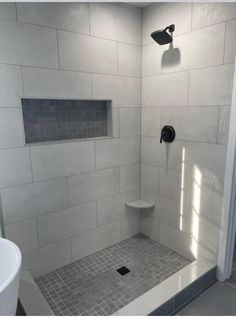 a bathroom with a shower, toilet and sink is shown in this image from the inside