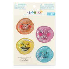 three colorful stickers with smiley faces on them