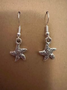 Silver starfish earrings on silver hypoallergenic nickel free fishhook earrings Casual Star Jewelry For Summer, Casual Star-shaped Summer Jewelry, Casual Summer Star Shaped Jewelry, Silver Casual Summer Earrings, Casual Silver Earrings For Summer, Casual Silver Summer Earrings, Beach Star Charm Earrings, Summer Starfish Charm Drop Earrings, Star-shaped Earrings With Star Charm For Beach