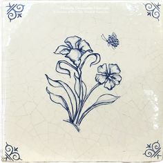 a blue and white tile with flowers on the bottom, and a butterfly flying over it