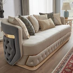 a living room filled with furniture and a red rug on top of a hard wood floor