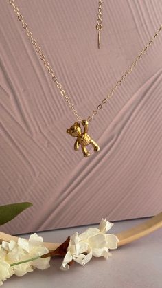 Step into a world of timeless sophistication with our GoldTeddy Bear Charm Chain Necklace. This exquisite piece seamlessly blends classic design with modern flair, featuring lustrous gold beads and charming details that elevate any ensemble. Dimensions: Teddy Bear Size: 21mm Chain Length: Available in 16 and 18 inches Bear Design Pendant Jewelry As Gift, Teddy Bear Necklace Aesthetic, Bear Necklace Simple, Teddy Bear Necklace, Teddy Bear Necklace Gold, Charm Chain, Bear Pendant, Bear Necklace, Gold Beads