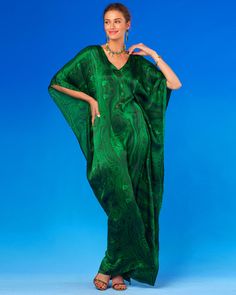 Our Esmeralda Silk Kaftan in Precious Malachite is the ultimate versatile dress that may be worn to a black tie gala or dressed down for stroll in a chic resort. At once bold and mysterious, our Esmeralda Kaftan in Precious Malachite conveys a jolt of the hypnotic deeply rich green stone that has captivated so many civilizations, from the Egyptians to the Aztecs and Europe, across a vast breadth of time. The Egyptians bestowed malachite with powers to ward off evil, while Faberge showcased its s Luxury Green Silk Evening Dress, Festive Silk Chic Kaftan, Formal Festive V-neck Kaftan, Luxury Silk Kaftan For Party, Festive Green Silk Maxi Dress, Fitted Kaftan For Evening In Summer, Fitted Kaftan For Summer Evening, Fitted Kaftan For Evening And Summer, Bohemian Evening Gown For Festive Occasions