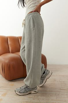 Everyone's favorite jogger sweatpants by Out From Under. Crafted from a so-soft knit in a cozy silhouette with a low-rise and a baggy fit through the legs. Finished with elastic cuffs at the hems. Find them only at Urban Outfitters. Features Out From Under Brenda jogger sweatpant Slouchy lounge pant Super soft knit Low-rise elasticated waistline with drawstring tie Side pockets Cinched elasticated hems Relaxed, slouchy fit Full length Easy pull-on style UO exclusive Content + Care 58% Cotton, 42% polyester Machine wash Imported Size + Fit Model in Black is 5’9" and wearing size Small Measurements taken from size Small Waist: 26" Inseam: 28" | Out From Under Brenda Jogger Sweatpant in Heather Grey, Women's at Urban Outfitters Low Rise Sweatpants, Florida Outfits, H&m Sweatpants, Baggy Sweatpants, Winter Shopping, Nike Sweats, Grey Sweatpants, Womens Sweatpants, Jogging Pants