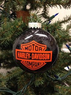 an ornament is hanging from a christmas tree with the words harley - davidson company on it