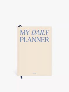 a book with the title my daily planner written in blue ink on top of it