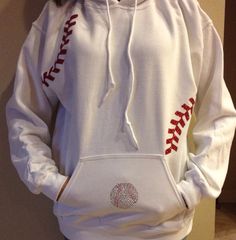 a person wearing a white baseball hoodie with red stitches