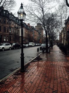 an empty street with cars parked on the side