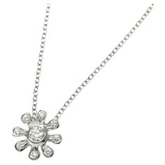 TIFFANY & Co. Platinum Paloma Picasso Diamond Daisy Pendant Necklace Metal: Platinum Chain: 16" Pendant: 9.10mm wide Diamond: 9 round brilliant diamonds, carat total weight .16 Hallmark: "TIFFANY&CO. PT950 Paloma Picasso" on chain tags Condition: Excellent condition, like new Limited edition, no longer available for sale in Tiffany stores Authenticity guaranteed Diamond Cross Necklace Tiffany, Diamond White Flower-shaped Necklace With Diamond Accents, Diamond Pendant Necklace Tiffany & Co., Luxury Silver Flower-shaped Diamond Necklace, 1960s Tiffany & Co. Jewelry, Platinum Chain, Daisy Pendant, Paloma Picasso, Elsa Peretti