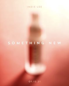 a bottle of something new on a red surface with the words something new in it