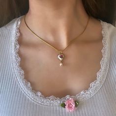 This dainty vintage gold heart necklace, adorned with a gold heart charm and freshwater pearls, makes a perfect coquette jewelry gift for her. A thoughtful gift for women who cherish delicate and vintage-inspired jewelry pieces.✨ 𝐃𝐄𝐓𝐀𝐈𝐋𝐒:  ⭐️ Gold Necklace Length available are 16" & 18"  ⭐️ Gold Heart charm size: 0.5in ⭐️ Heart charms are gold plated over metal & includes a freshwater pearl dangling at the bottom of the floral heart charm. The dainty chain necklace is made out of stainles Necklace Coquette, Coquette Jewelry, Dainty Chain Necklace, Dainty Gold Jewelry, Coquette Vintage, Vintage Coquette, Pearl Necklace Earrings, Vintage Inspired Jewelry, Pearl Jewelry Necklace