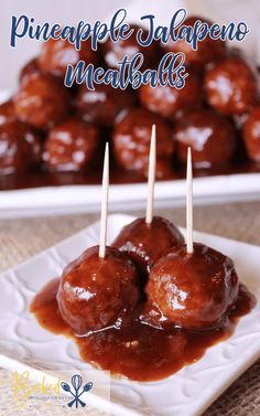 some meatballs are sitting on a plate with toothpicks in them