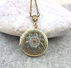 Antique style teal locket pendant. This locket is the perfect gift for her. Beautiful filigree handcrafted brass locket with a glass like resin finish. The locket measures approx 31mm and is hanging on an antiqued brass chain, please choose your length at checkout.   Inside of the locket are two spaces for photo's etc to be glued in.  The locket will arrive in a little gift box  ready for giving. Gorgeous quality and details. Would highly recommend as a special gift So beautiful!! Honestly it's Antique Gold Medallion Locket Necklace In Bohemian Style, Antique Gold Bohemian Medallion Locket Necklace, Bohemian Antique Gold Medallion Locket Necklace, Bohemian Brass Locket Necklace, Antique Gold Bohemian Locket Necklace, Bronze Bohemian Locket Necklace, Bohemian Brass Medallion Locket Necklace, Blue Medallion Locket Necklace As Gift, Bohemian Nickel-free Locket Necklace Gift