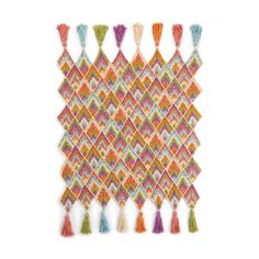 a multicolored wall hanging with tassels and fringes on white background