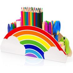 an assortment of colored pencils and crayons in a rainbow shaped holder on a white background