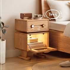 a wooden nightstand with an electronic device on it